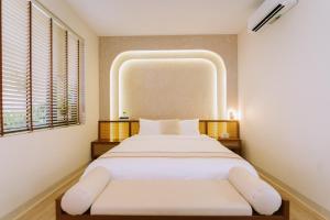 Postel nebo postele na pokoji v ubytování Chingu Boutique Vũng Tàu + 49 fotografií