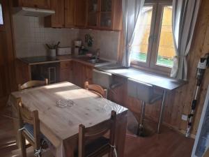 a kitchen with a table and a sink and a window at ZEcamping 2 étoiles animaux acceptés snack-bar et vue lac in Neffes