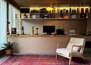 a bar with a white chair and a desk at Turpan Grape Spring Inn in Turfan