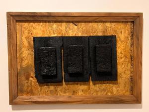 un'immagine di quattro libri in una cornice di legno di Biez Homestay a Karatu