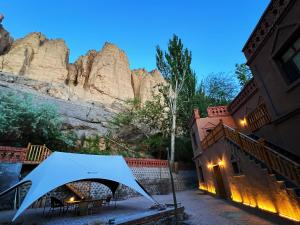 a tent is set up in front of a mountain at Turpan Grape Spring Inn in Turfan