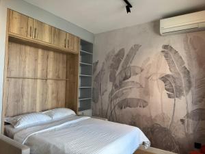 a bedroom with a bed and a wall mural at BW Lux Apartments in Sajmište