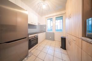 uma cozinha com armários brancos e um fogão com forno em appartement confortable à la frontière de bâle One 6 personnes em Saint-Louis