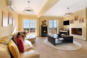 a living room with a couch and a coffee table at Vila Picota in Cerro da Zorra