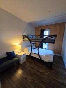 a room with two bunk beds and a couch at Chez Temporel - Condo urbain in Quebec City +2 photos