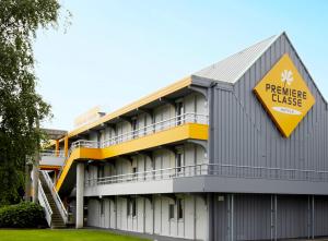 a building with a yellowurance clause sign on it at Premiere Classe Marne la Vallée - Torcy in Torcy