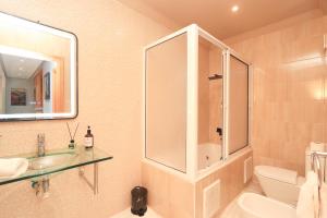 a bathroom with a sink and a shower and a toilet at Ocean View Apartment by Hilton & TGV Station in Tangier +38 photos