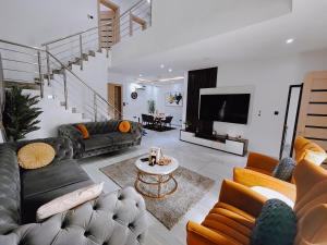a large living room with couches and a tv at Sahara Apartment Ikoyi in Lagos