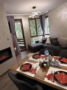 a living room with a table and a couch at Dream Apart - Iceberg in Pamporovo +17 photos