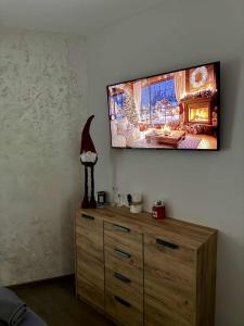 a room with a dresser with a television on the wall at Dream Apart - Iceberg in Pamporovo