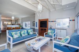 a living room with blue couches and a table at 163 on Kusweg in Hartenbos