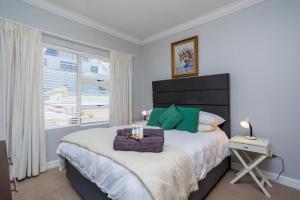 a bedroom with a large bed and a window at 163 on Kusweg in Hartenbos +14 photos