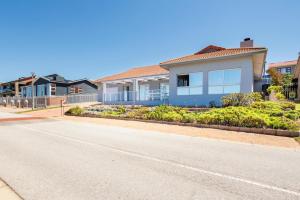 a house on the side of a road at 163 on Kusweg in Hartenbos