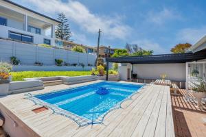a swimming pool in the backyard of a house at 163 on Kusweg in Hartenbos