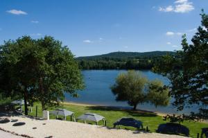 a view of a lake with a group of tents at Glamping Bříza in Cheb