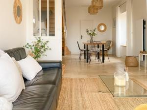 a living room with a couch and a table at La Cour Tellier in Rilly-la-Montagne