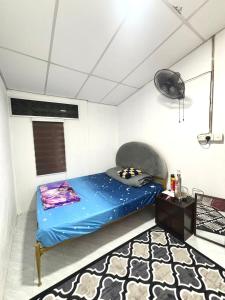 a room with a blue bed in a room at Homestay Abah , Kota Bharu, Kelantan in Kota Bharu