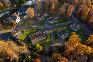 an aerial view of a house in a forest at Domaine de Haslach, The Originals Collection, Résidence de Tourisme in Munster
