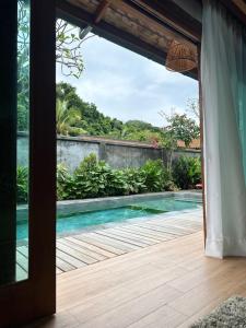 a view of a swimming pool from a house at The Temak Villa in Pantai Cenang