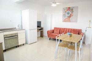 a kitchen and living room with a table and a couch at Panoramic View in Ducos