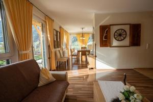a living room with a couch and a table at Chalet Olympia in Neustift im Stubaital