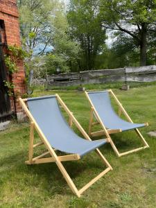 two chairs sitting on the grass in a yard at Haevn Altes Pfarrhauss Marienfliess in Stepenitz