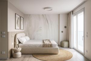 a bedroom with a bed and a large window at Vibra Tahiti Deluxe in Lido di Jesolo