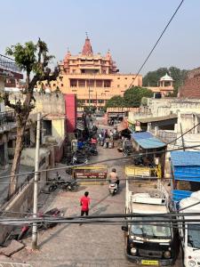 a city street with a large building in the background at Divine Stay- Only Prime Property In Front Of The Krishnas Birthplace Janambhumi Temple, Food-Shopping-Transport All At Your Doorstep in Mathura