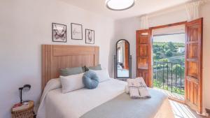 a bedroom with a bed with a large window at Los Cortinales Setenil de las Bodegas by Ruralidays in Setenil