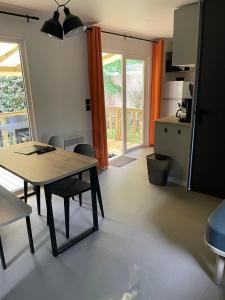 a kitchen and dining room with a table and chairs at Camping 3 étoiles - ccaaafd in Sorèze