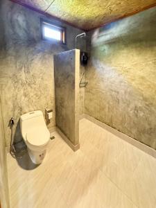 a bathroom with a toilet and a shower at Painon Resort KohLanta in Ko Bu Bu +90 photos