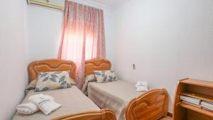 a small room with two beds and a window at Villa Josara by Ruralidays in Huelva +19 photos
