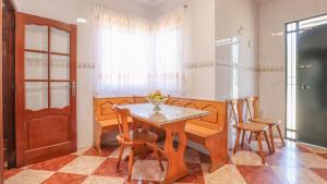 a dining room with a wooden table and chairs at Villa Josara by Ruralidays in Huelva