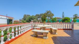 a table and two benches on a balcony at Villa Josara by Ruralidays in Huelva