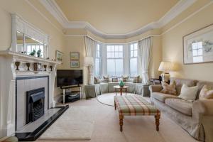 a living room with a couch and a fireplace at Ampersand in Earlsferry