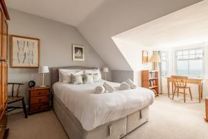 a bedroom with a large bed with towels on it at Ampersand in Earlsferry
