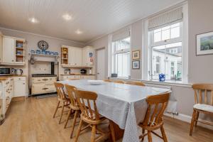 a kitchen and dining room with a table and chairs at Ampersand in Earlsferry