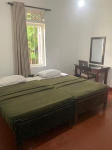 a large bed in a room with a window at Cityscape Bungalow in Bandarawela +7 photos