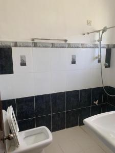 a bathroom with a toilet and a sink at Cityscape Bungalow in Bandarawela