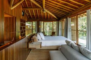 a bedroom with a bed and a couch at Villa 21 in Itacaré +59 photos