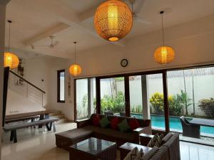a living room with a couch and a pool at Villa Rob in Kerobokan