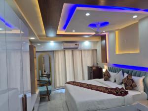 a hotel room with a bed and a blue light at Hotel Grand Luxury Char Dham in Vrindāvan