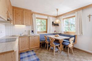 a kitchen with a table and chairs in a room at Villa Bernhard in Siusi +23 photos