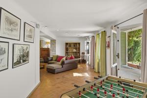 a living room with a pool table and a couch at Villa vue mer panoramique & piscine chauffée in Toulon