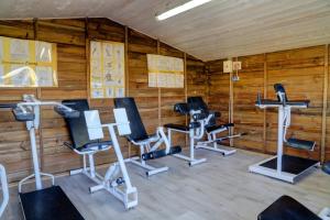 a gym with several exercise bikes and treadmills at Camping 3 étoiles - Piscine - eeeddg in Saint-André-des-Eaux