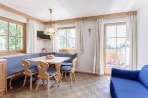 a living room with a table and chairs at Villa Bernhard in Siusi