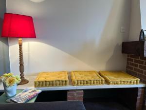 a table with two beds on it with a lamp at Maison authentique en bord de Meuse in Joigny-sur-Meuse