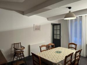 a dining room with a table and chairs at Maison authentique en bord de Meuse in Joigny-sur-Meuse +23 photos