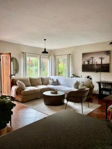 a living room with a couch and a table at Spacious 2-bed, 2-bath villa with garden and parking in Nelspruit