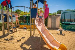 eine Gruppe von Kindern, die auf einem Spielplatz spielen in der Unterkunft Camping 4 étoiles - Piscine - eei0fg in La Faute-sur-Mer